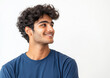 © PRASANNAPIX - indian young man wearing a blue t-shirt, smiling and looking to the side, standing isolated on a white background.