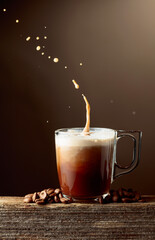 Wall Mural - Coffee and chocolate drink with cream on a brown background.