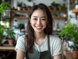 © Vilshanskaia_Alla - Young woman smiles in a vibrant plant shop