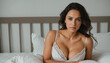 © Faiqdesigner - A woman in bed exuding natural beauty and subtly showcasing cleavage