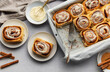 © Olena Rudo - Freshly baked cinnamon rolls with cream cheese frosting and cinnamon sticks