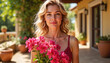 © Mikhael - Woman smiling with pink flowers against a sunny patio background