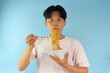 © Lailar Studio - Asian man eating noodles with a shocked expression