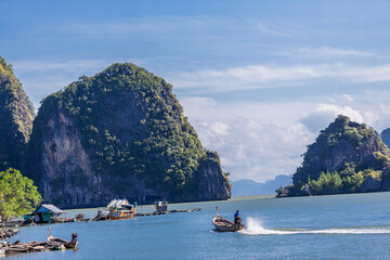 Wall Mural - A distant natural background of a large mountain in the middle of the sea, Phang Nga Bay, Thailand, from a major viewpoint where tourists come to watch the sunrise in the morning.