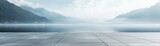 Minimalistic terrace with foggy mountains, empty concrete floor, blue-gray tiles, ideal for branding and product showcases.