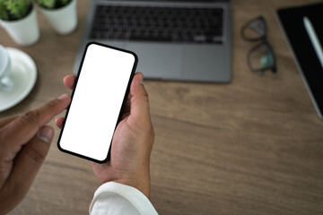 Wall Mural - top view mockup image hand using a smartphone man holding cell phone with blank screen