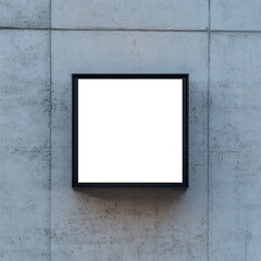 Aufkleber - A black square frame is mounted on a light gray concrete wall providing a blank space for signage or display.
