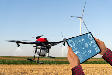 Poster - Farmer controls drone sprayer with a tablet. Smart farming and precision agriculture.