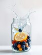 © Kreingkrai - an image of a jar filled with fruit and water with a splash of water.