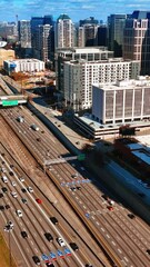 Wall Mural - Flight above the highways with busy traffic. Top view on the downtown of Atlanta, Georgia, USA on sunny autumn day. Vertical video