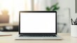 © olga_demina - Open laptop displaying a blank white screen is placed on a wooden desk in a blurred home office setting, providing an ideal space for design mockups or showcasing digital content