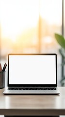 Aufkleber - Laptop computer featuring a blank screen mockup sits on a work desk adorned with stationery and plants, illuminated by natural light from a large window, enhancing a bright workspace