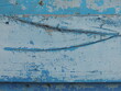 © Skyliz - old board close-up with crack in structure and remains of blue paint, rustic exterior element made of wood and metal with flakes of peeling old blue paint