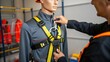 © DigitalSpace - A closeup of a fall protection system being demonstrated in training with a safety instructors hands adjusting a harness on a mannequin highlighting the importance of proper fit