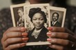© SerPak - Nostalgic memories: african american hands holding vintage black and white portraits. Black History Month