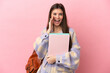 © luismolinero - Young student woman isolated on pink background shouting with mouth wide open