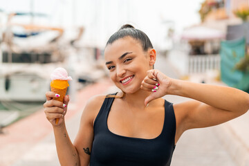 Poster - Young pretty woman with a cornet ice cream at outdoors proud and self-satisfied