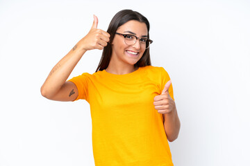 Wall Mural - Young caucasian woman isolated on white background giving a thumbs up gesture