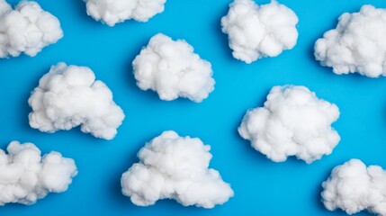 Cloud Nine: A whimsical and playful arrangement of fluffy white clouds against a vibrant blue background. The clouds, resembling cotton balls, create a sense of wonder and lightheartedness.