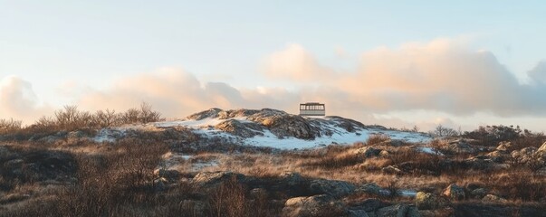 Wall Mural - Serene Winter Landscape with Observation Tower Against a Warm Sunset Sky