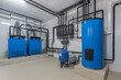 © alhim - The autonomous gas boiler house is equipped with blue storage tanks and piping systems for efficient operation in the maintenance area.