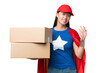 © luismolinero - Super Hero delivery Asian woman holding boxes over isolated background saluting with hand with happy expression
