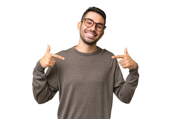 Young handsome caucasian man over isolated background proud and self-satisfied