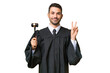 © luismolinero - Judge caucasian man over isolated background smiling and showing victory sign