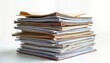 © Viktor - High stack of papers, documents. Office papers stacked on desk. Messy paperwork pile shows heavy workload. Business documents accounting files likely await organization. White background isolates