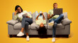 © Prostock-studio - Gadgets addiction. Young black family of three holding and using different electronic devices while sitting on sofa on yellow background. Parents and their daughter with modern gadgets