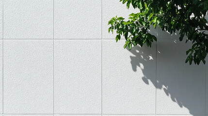 Wall Mural - clean white wall with slight stipple texture, featuring shadow cast by green leaves. simplicity and contrast create serene atmosphere