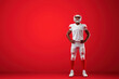 © Mselected - Football player posing confidently against a solid red background during training session