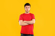 © Prostock-studio - People Emotions Concept. Portrait of offended pensive young casual man posing with folded arms, standing isolated on blue studio background. Angry guy holding hands crossed, looking at camera