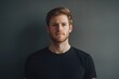 © Alexandr - Man in Black Shirt Standing Against Gray Wall