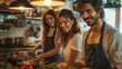 © visoot - Three happy people in a kitchen, with one cooking dinner while the others are enjoying the moment. The atmosphere is warm and cheerful.