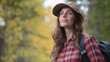 © EpicVisuals - Young Woman in Plaid Shirt and Hat Walking Outdoors in Nature