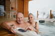 © Halfpoint - Romantic wellness getaway. Senior couple enjoying hot tub during Valentine's weekend.