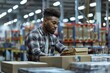 © Viktoriia - Focused warehouse worker organizing boxes in modern distribution center