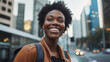 © InspirationDesign - Cheerful Black woman in urban setting. Shows optimistic lifestyle and city energy