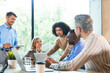 © ty - Business team discussing together business plans in office.