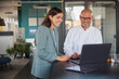 © Westend61 - Businessman and woman attending meeting at office