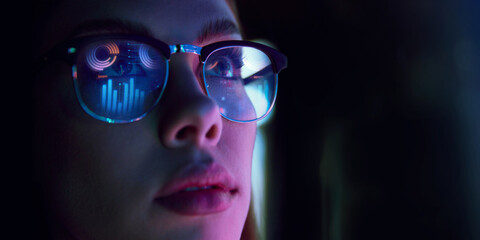 Close-up of businesswoman in glasses reflecting digital graphs, symbolizing data analysis, e-commerce analytics, strategy. Concept of business, modern technologies, finance, investment, digital market