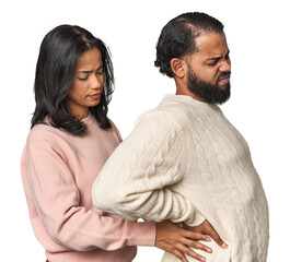 Wall Mural - Young Latino couple in studio suffering a back pain.