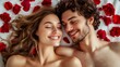 © PUKPIK - Romantic Couple Smiling Amidst Red Rose Petals on White Bed