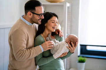 Wall Mural - Family love parenthood baby concept. Parents spend happy moments with the newborn child