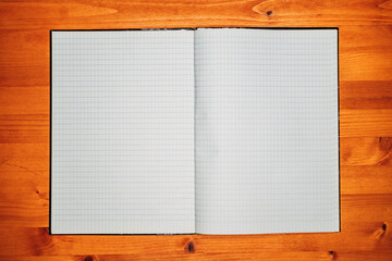 Top view of open empty notebook with rectangular grid pattern pages