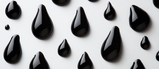 Poster - Black droplet shapes on white surface with negative space for text or graphics perfect for backgrounds or creative designs