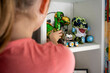 © Connect Images - Child reaches for colorful plush toys on a white shelf, with a focus on the child's hand and the toys, Netherlands