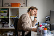 © Connect Images - A man sitting at a desk in an office, appearing stressed or contemplative, rests his hand on his forehead while looking at a computer screen, Nijmegen, Netherlands
