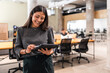 © ADDICTIVE STOCK - Coworkers in modern office collaborating with tablet technology